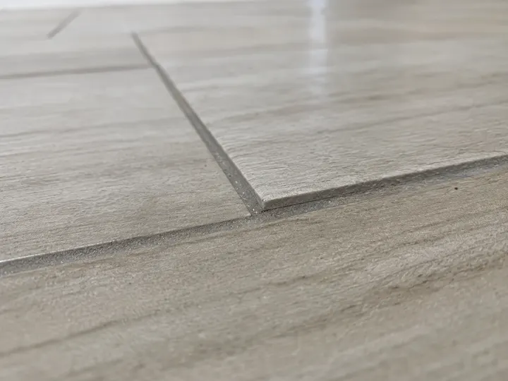Uneven tile lippage at a floor transition